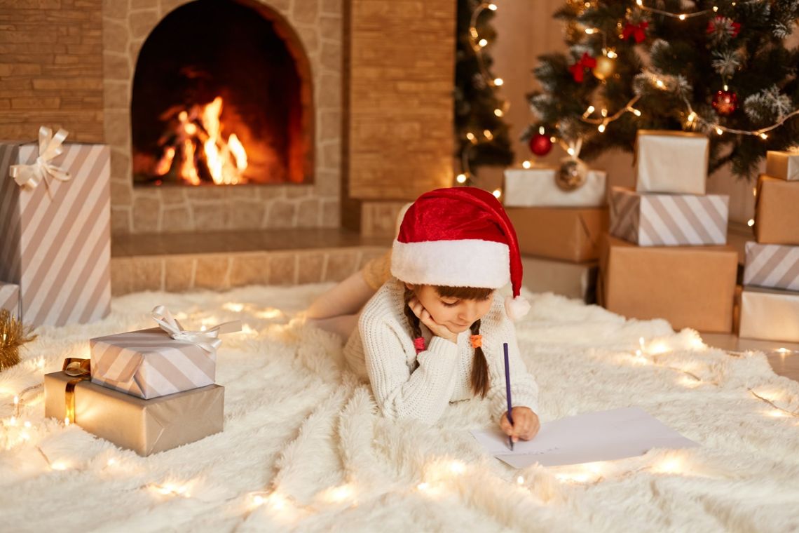 Child writes a Christmas wish list.